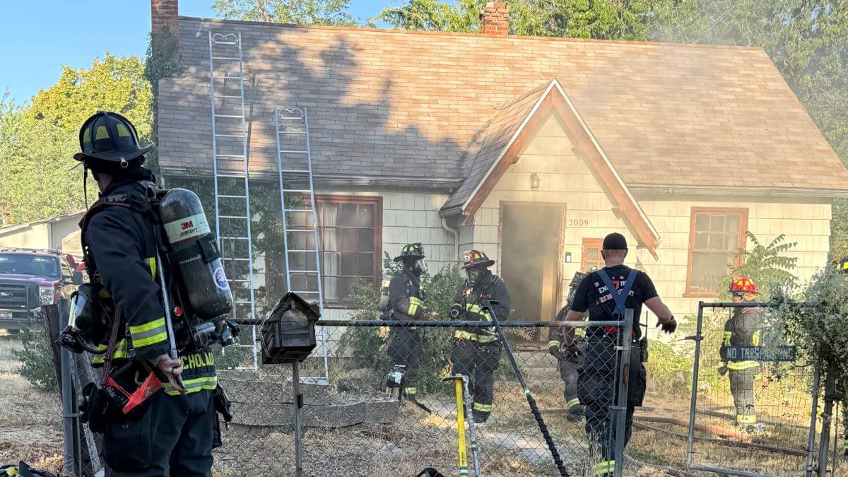 A house surrounded by firefighters