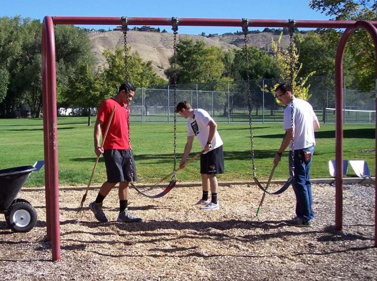 group of volunteers mulching at a playground