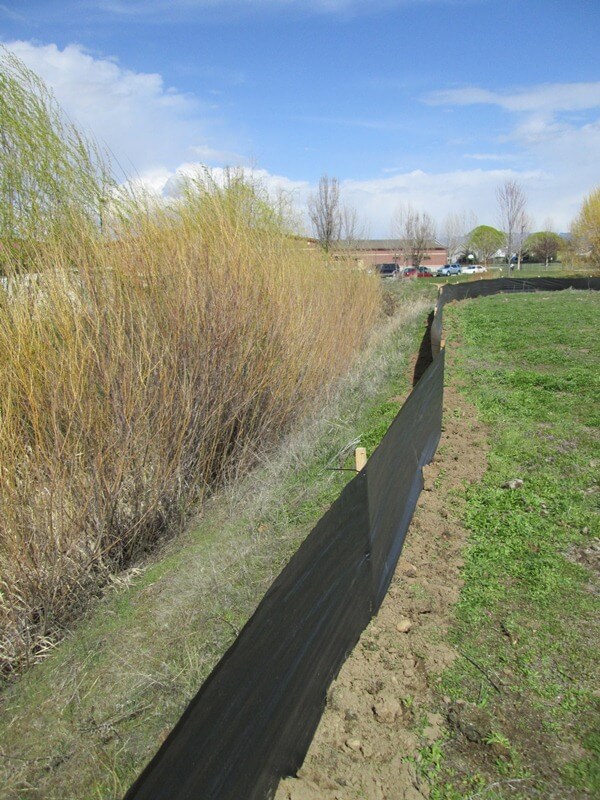 Silt fence around a grassy area