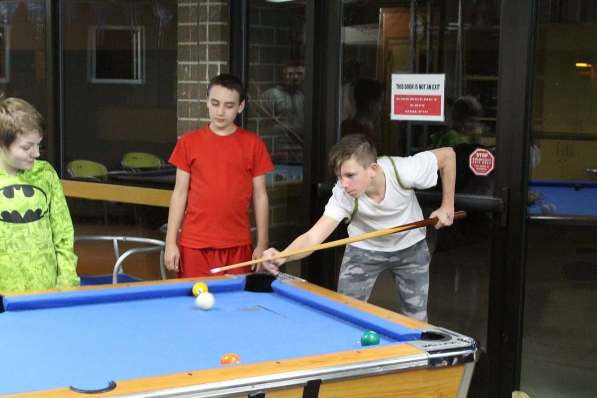 Teens playing pool