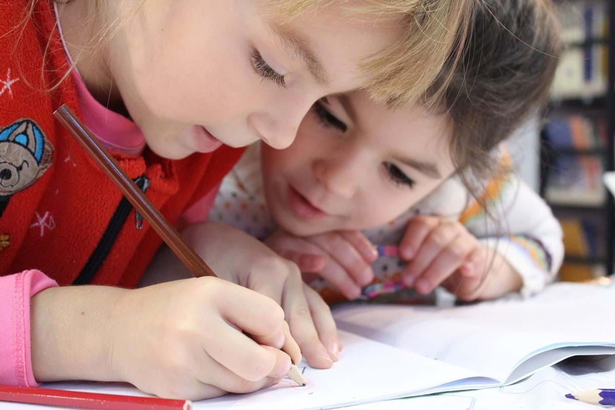 two kids drawing in an art class
