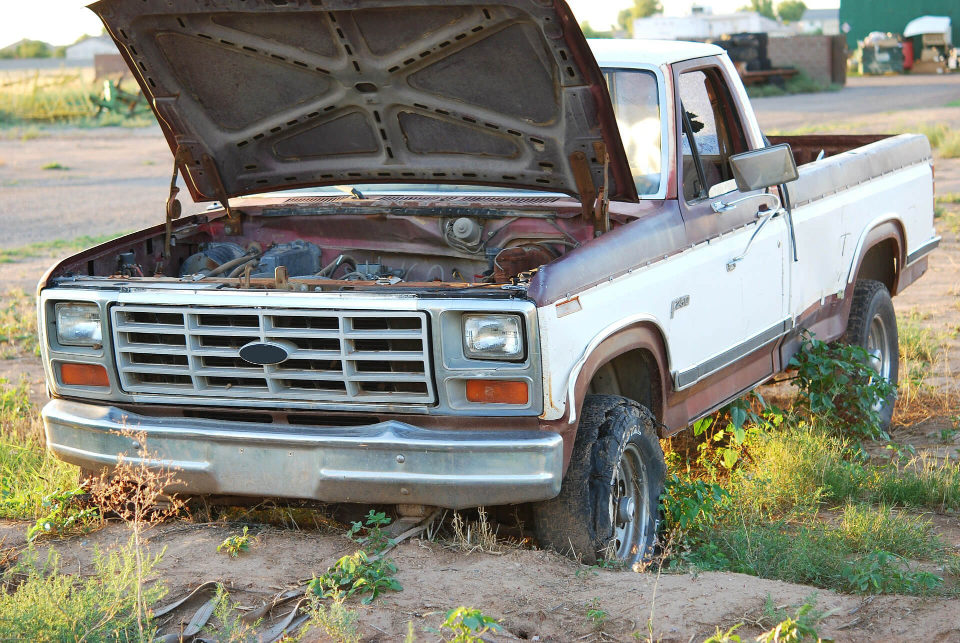 Abandoned truck with hood open.