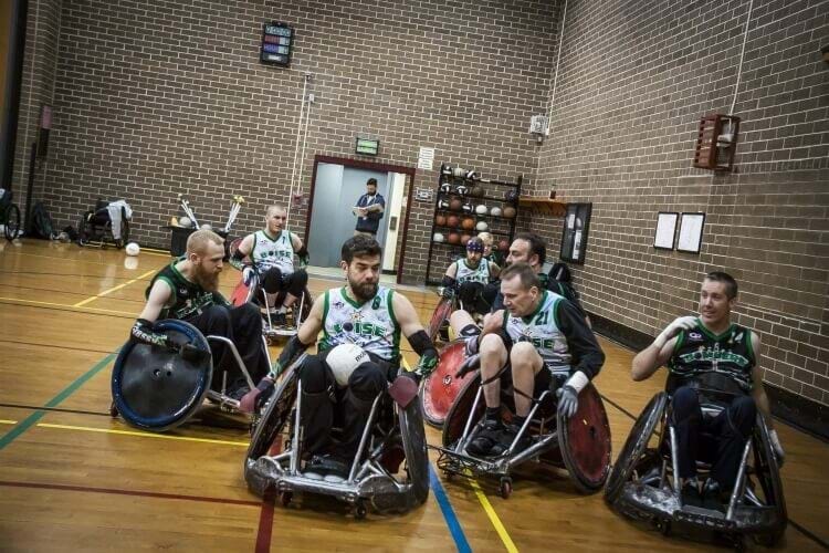 Group of individuals playing wheelchair rugby