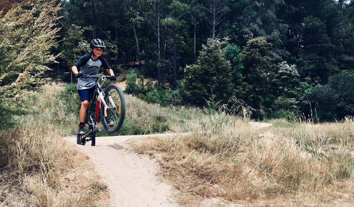 Young boy riding his mountain bike in the mountains