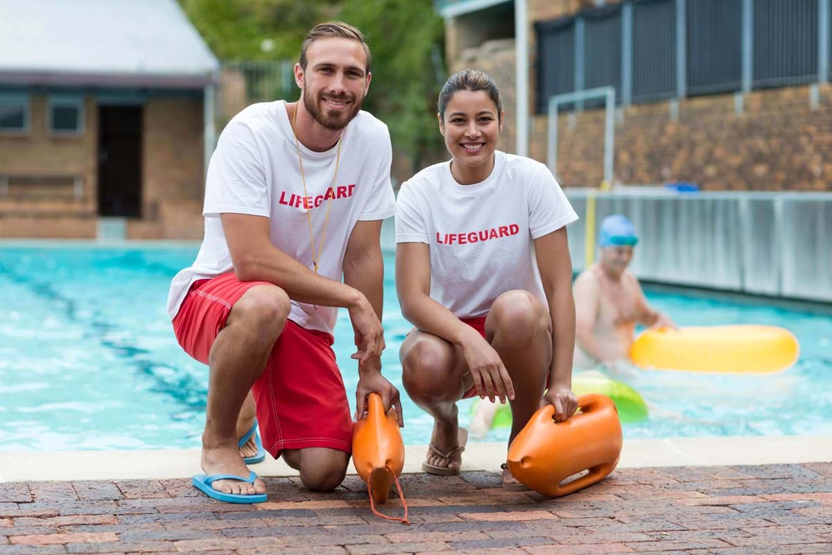 two lifeguards at a swimming pool
