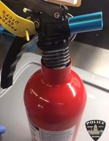 Close up of the top of a fire extinguisher