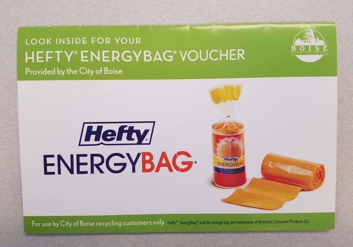 Front image of a postcard with words Hefty Energy Bag and image of orange plastic bags