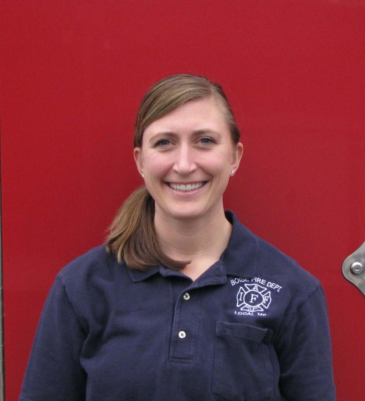 Female with blue polo shirt with Boise Fire logo on it.