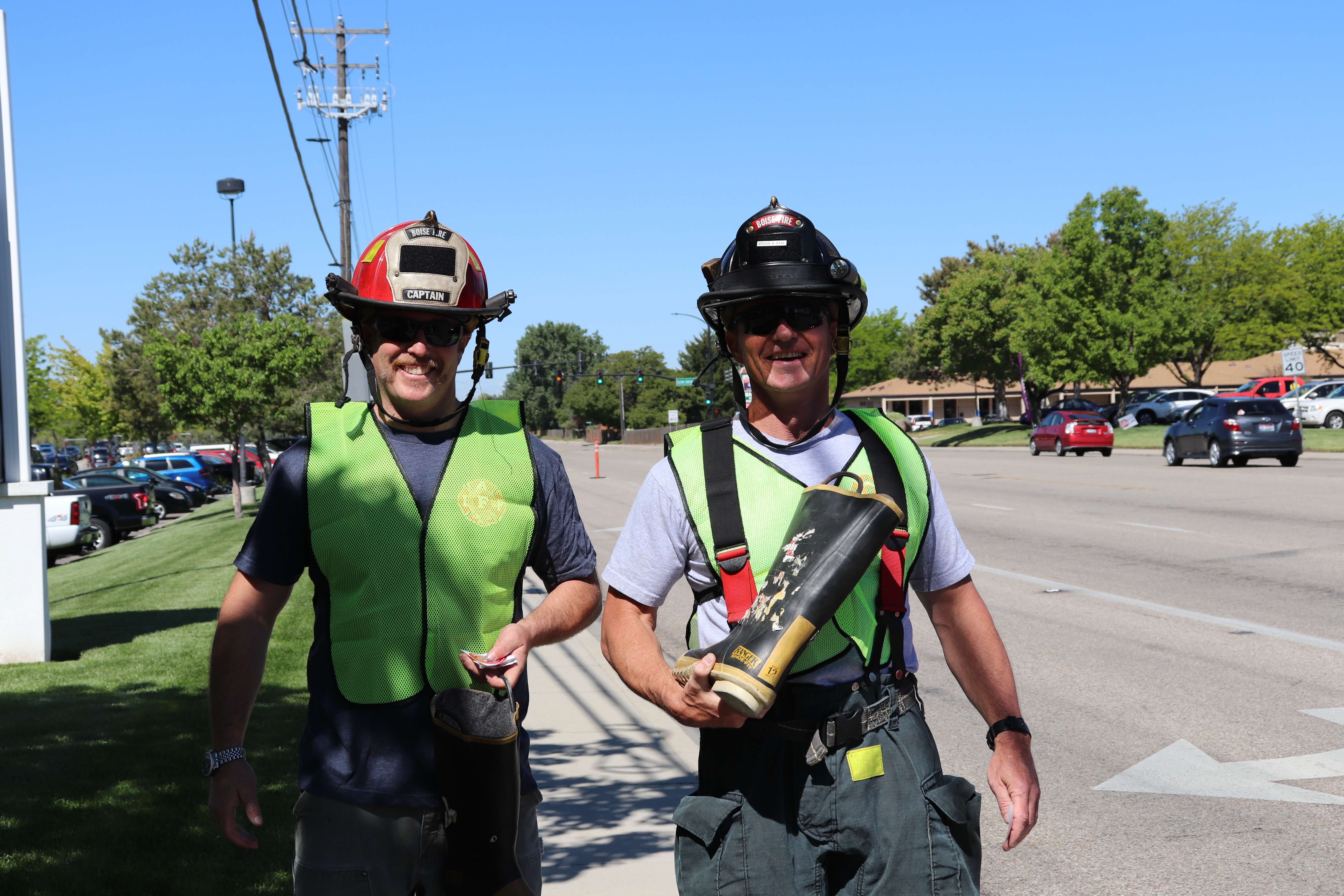 Firefighters working fill the boot outside on the street