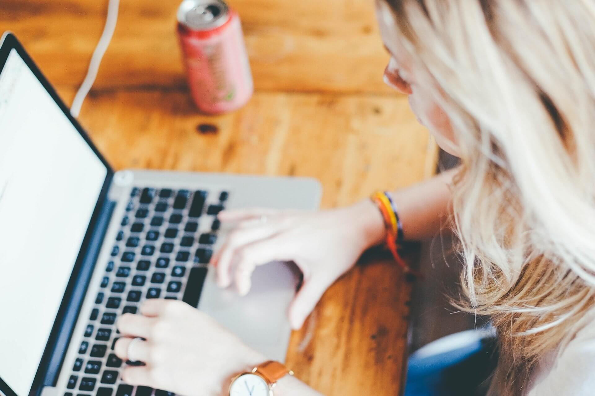Person sitting at a table with a laptop.