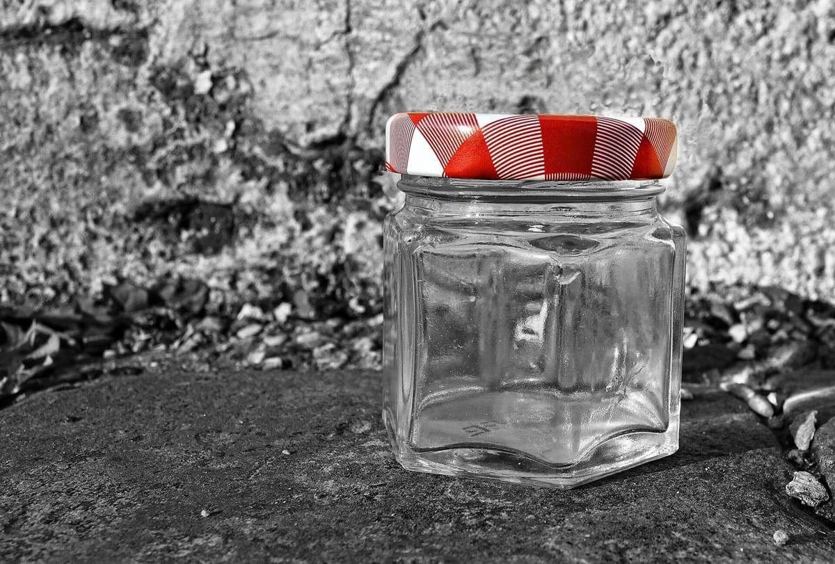 glass jar with red metal lid.