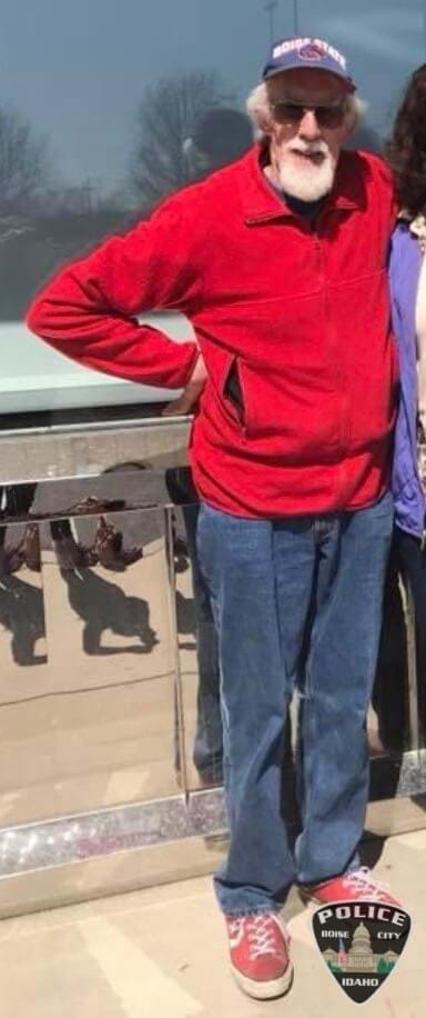 Missing: John is 6’3” tall and weighs approximately 155 pounds.  He has gray hair and brown eyes.  He was wearing the same red coat as the one he is pictured in below. He was also wearing the blue baseball cap in the second photo. John was also last seen carrying a maroon camera case and possibly an